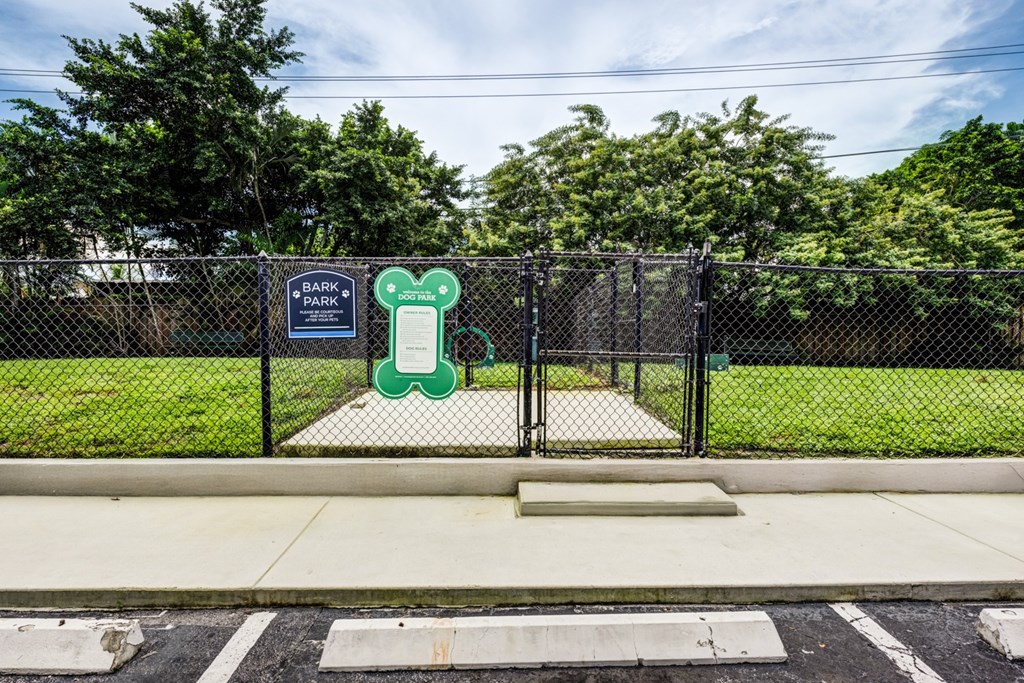 Fenced dog park at Coronado Springs East Apartments in Palm Springs, Florida, offering a leash-free area for pets to play within this pet-friendly community.