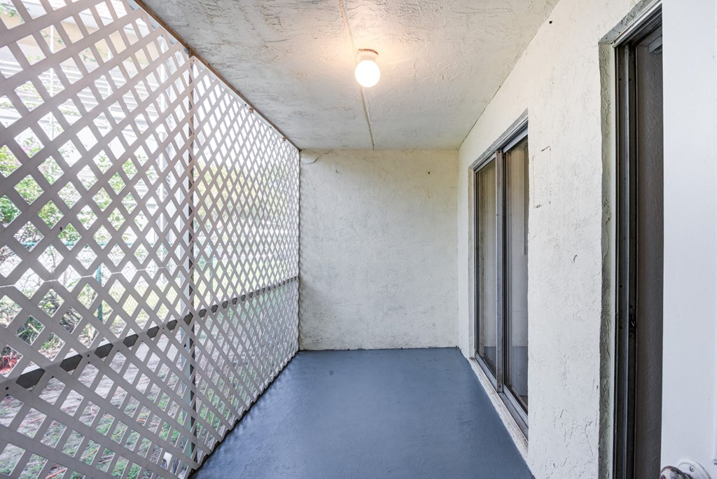 an empty room with a screened in porch and a window