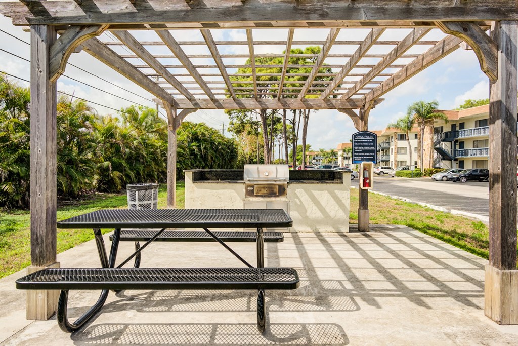 a picnic area with a bench and a picnic table