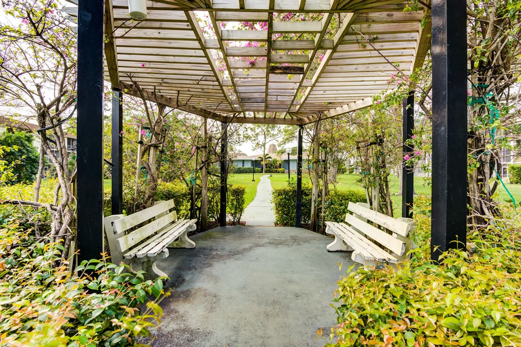 a group of benches sitting under a covered walkway