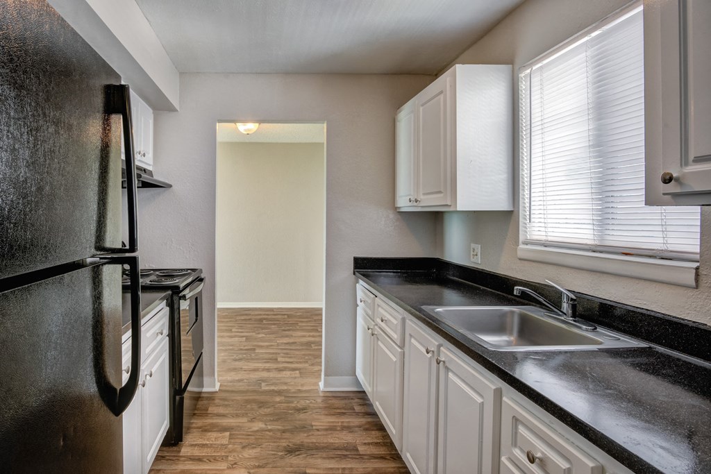 the preserve at ballantyne commons apartment kitchen with black counter tops and white cabinets