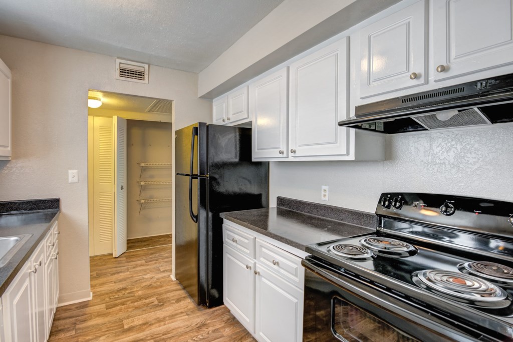 the preserve at ballantyne commons apartment kitchen with stove and refrigerator