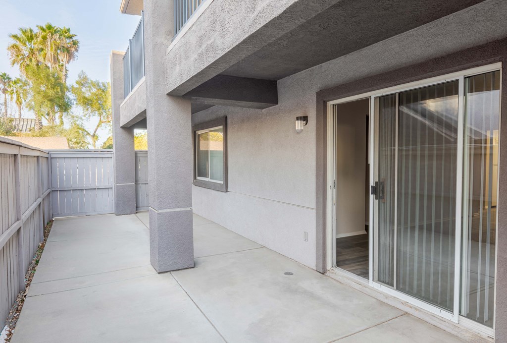 the patio of a condo building with a glass door