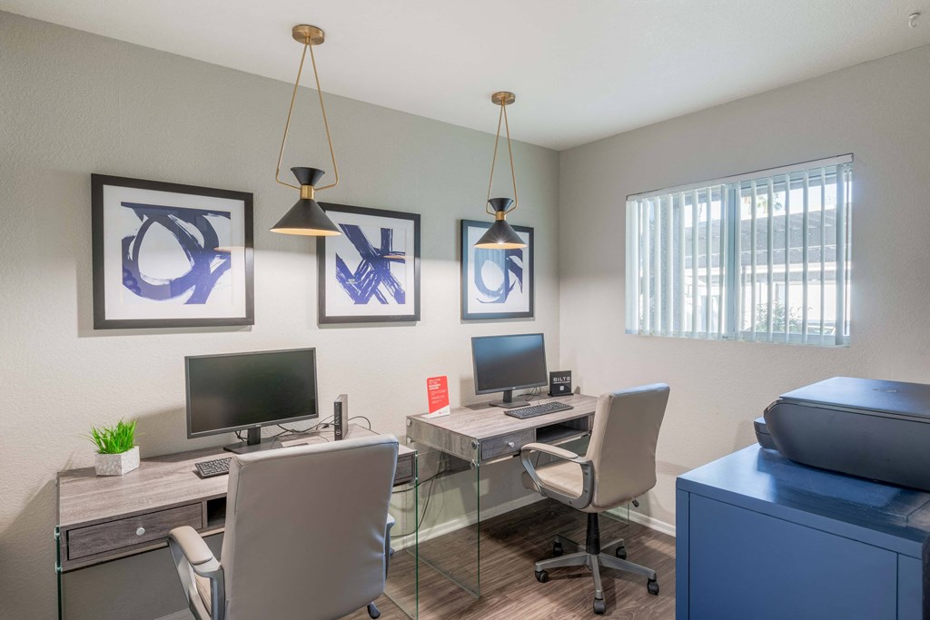 our apartments have an office with two desks and chairs and a tv
