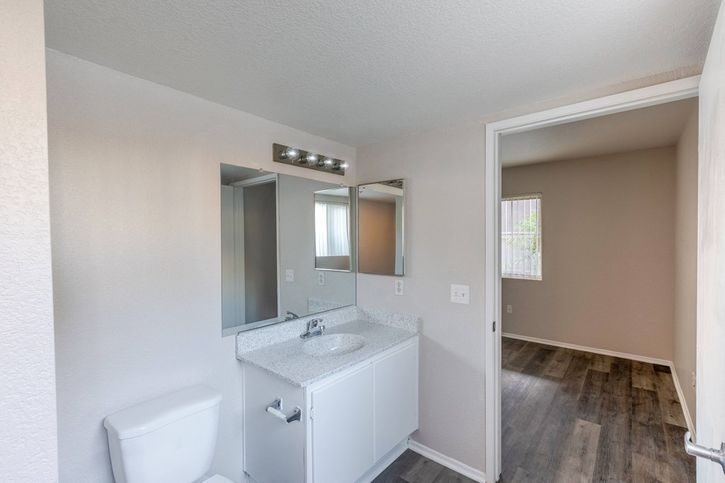 an empty bathroom with a mirror and a toilet