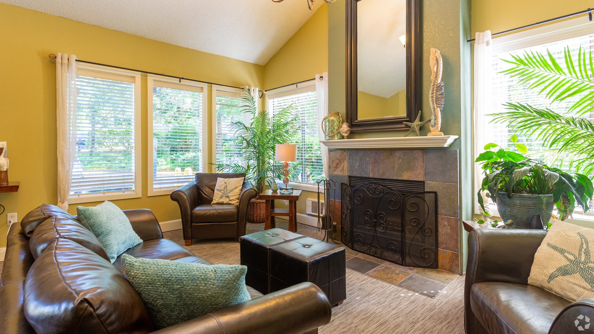 a living room with leather furniture and a fireplace