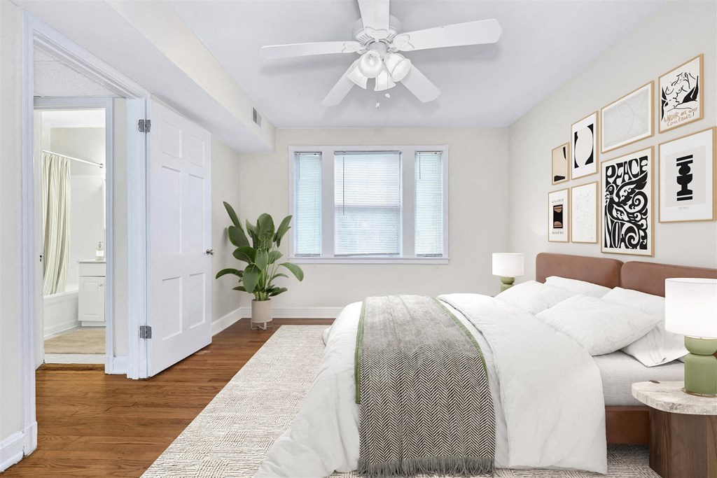 an open bedroom with a bed and a ceiling fan