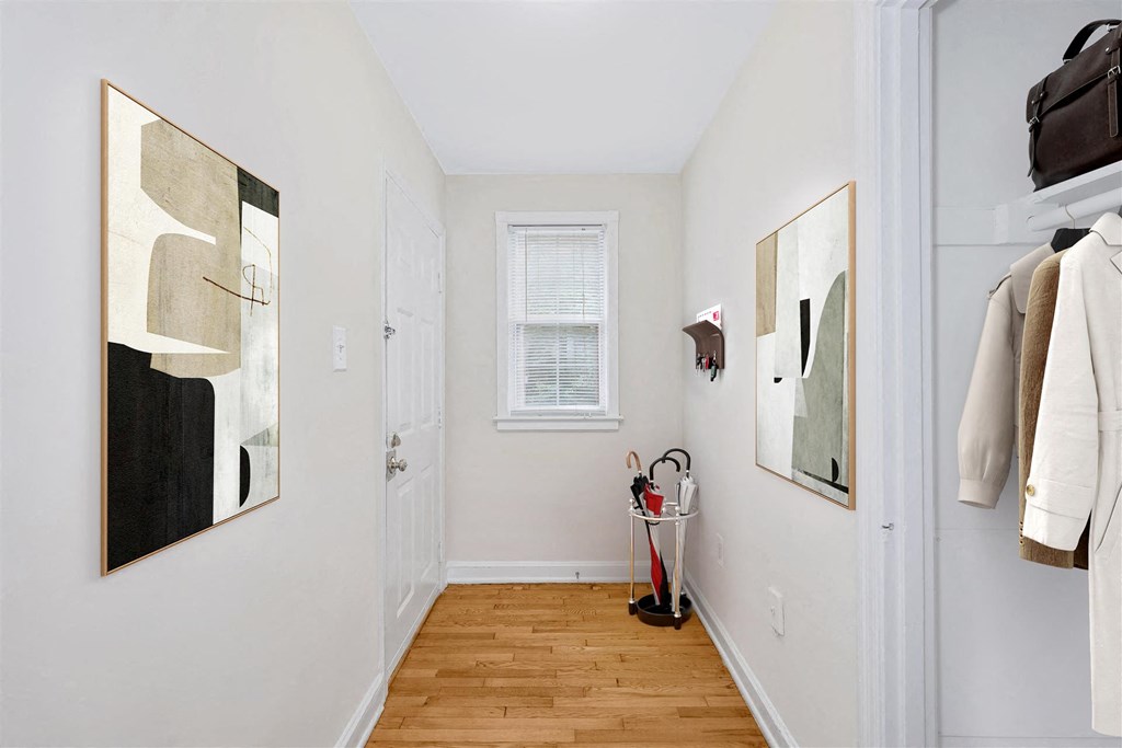 a hallway with a door to a closet and a window