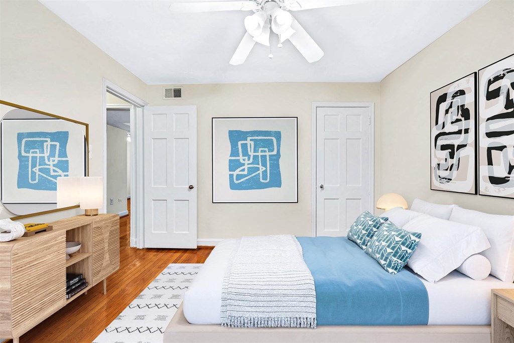a bedroom with a large bed and a ceiling fan