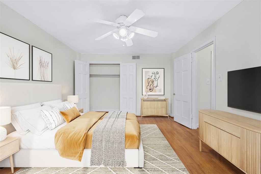 a bedroom with a large bed and a ceiling fan
