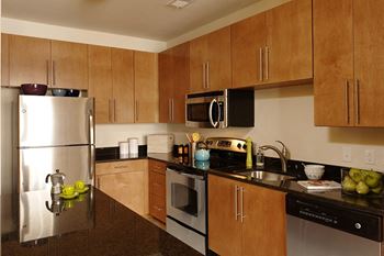 a kitchen with stainless steel appliances and wooden cabinets
