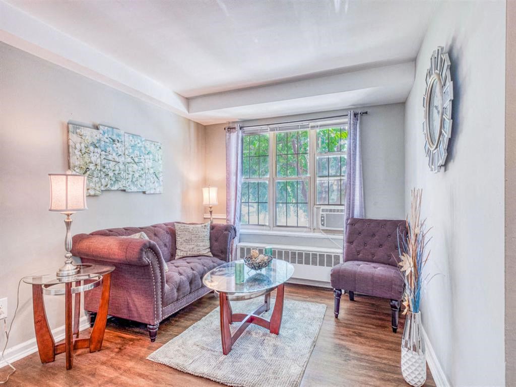 a living room with a couch and a table and a window