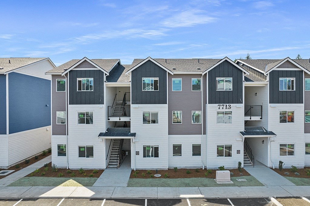 exterior view of a row of multicolored apartment buildings,