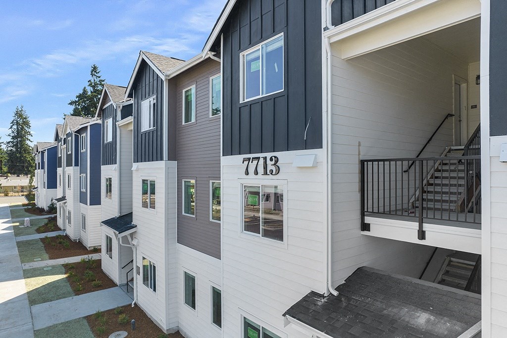 exterior view of a row of multicolored apartment buildings,