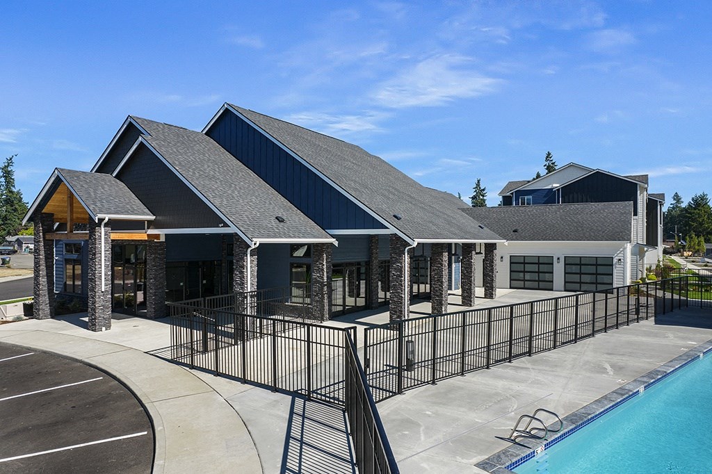 building exterior of leasing center  with a pool to the right,