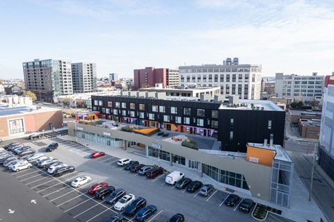A parking lot with cars and a building in the background.
