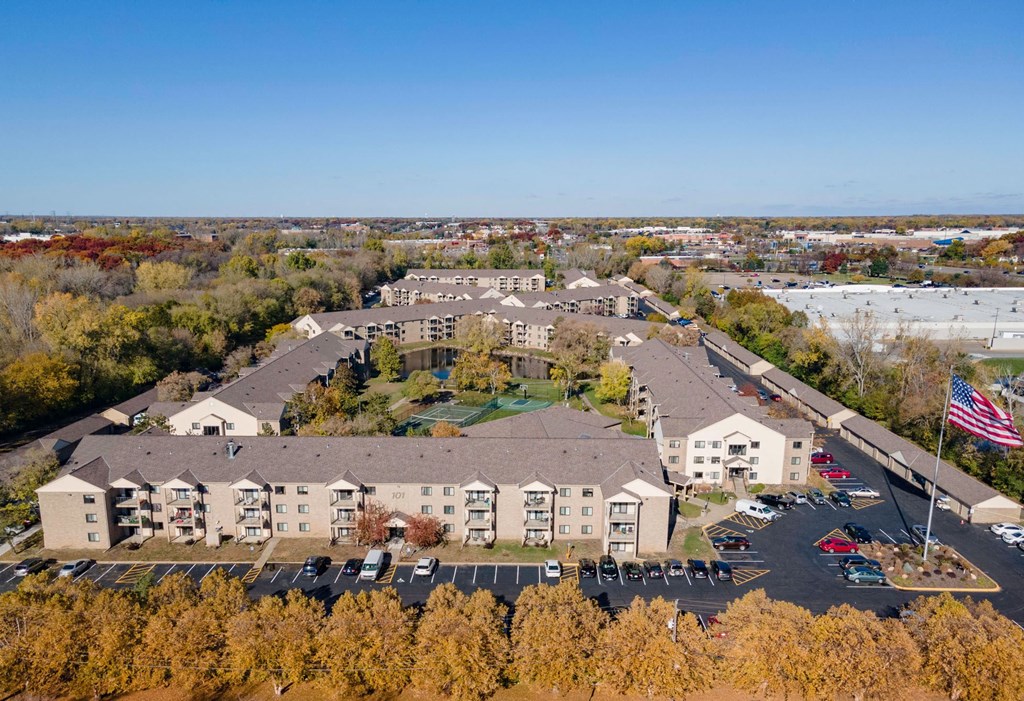 an aerial view of an apartment complex with an flag out front