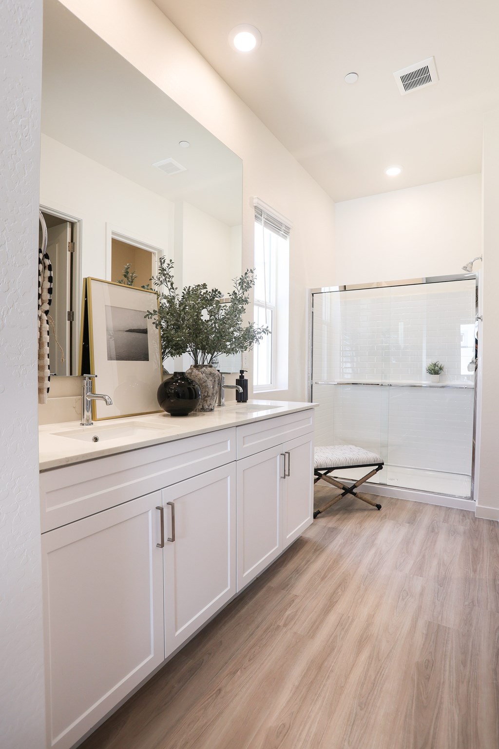 A bathroom with a white cabinet and a white sink.