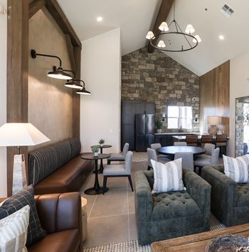 A living room with a stone wall and a large sectional sofa.