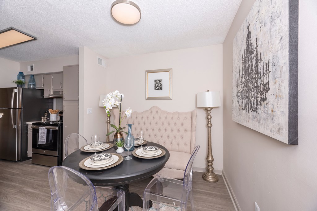 a dining room with a table and chairs and a kitchen