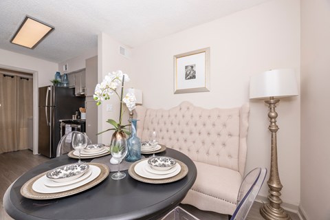 a dining room with a table and a couch in a living room