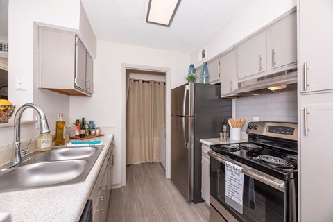 a kitchen with stainless steel appliances and white cabinets