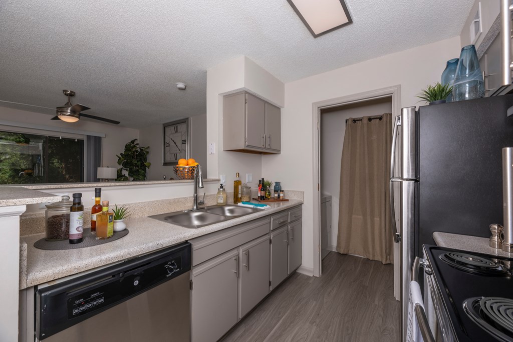 redesigned kitchen with stainless steel appliances and granite counter tops and a large window