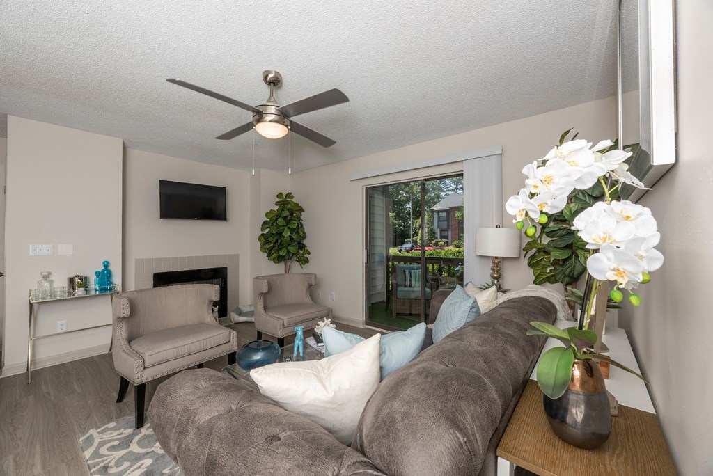 a living room with a couch and a ceiling fan