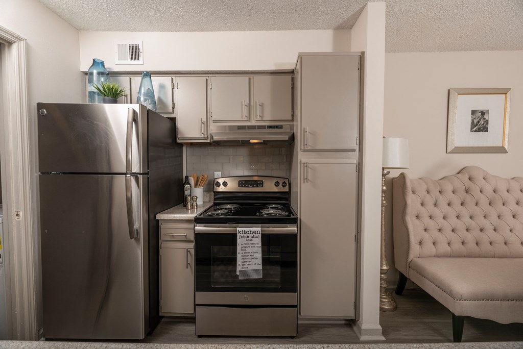 Lawrenceville, GA Apartments – Park on Sweetwater – a kitchen with stainless steel appliances and a stainless steel refrigerator