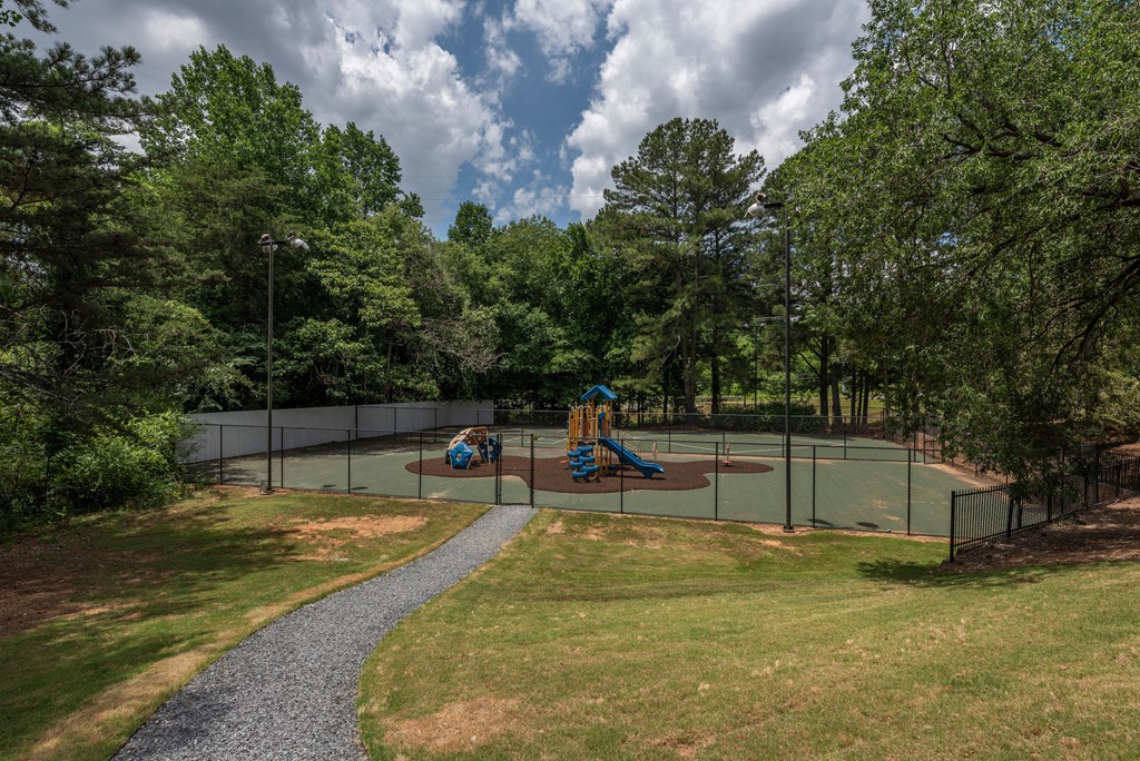 a tennis court with two kids playing on it