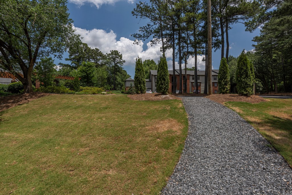 a view of a house from a gravel driveway