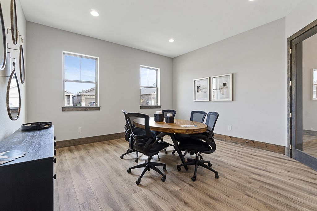 a dining room with a table and chairs and a window
