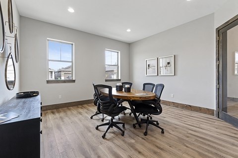 a dining room with a table and chairs and a window