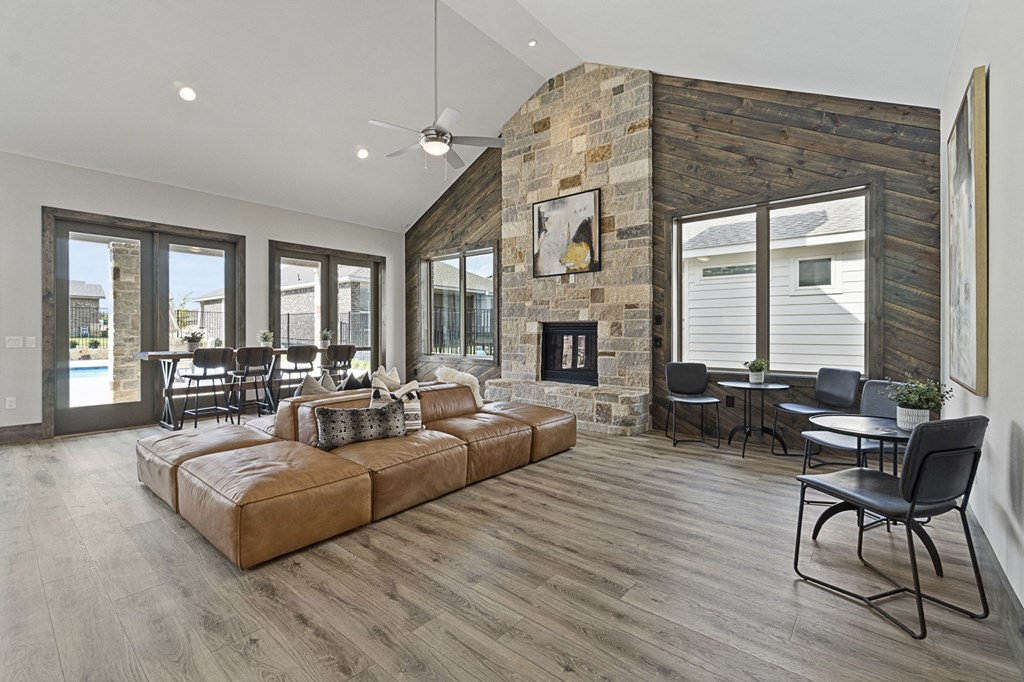 a living room with a couch and a table with chairs and a fireplace