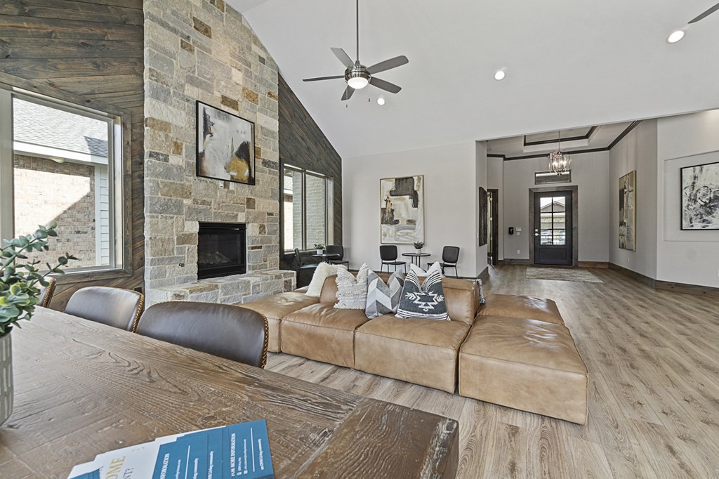 a living room with a large couch and a stone fireplace