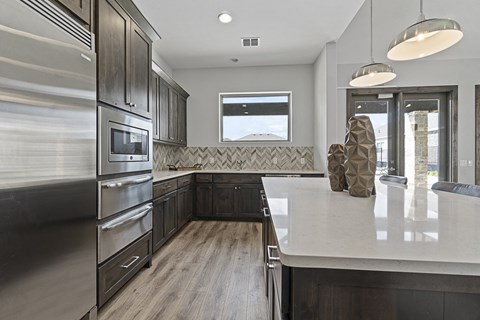 a kitchen with stainless steel appliances and a white counter top