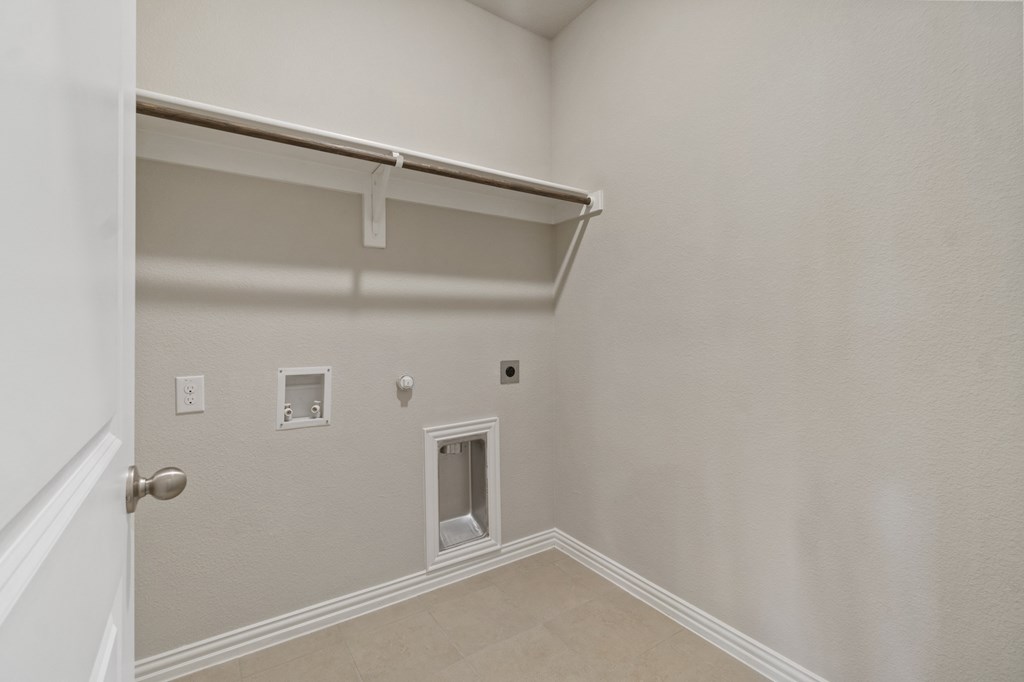 an empty room with a white wall and a door to a closet