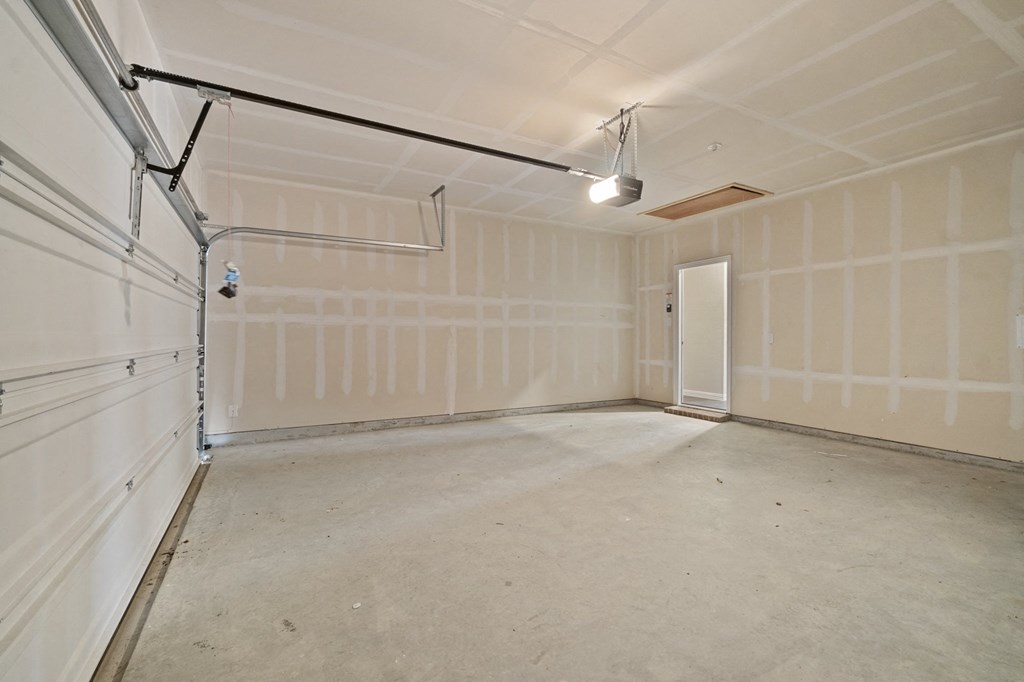 the interior of a garage with a white wall and a door