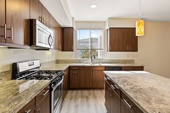 a kitchen with wooden cabinets and granite countertops