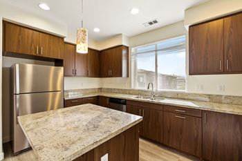 a kitchen with wooden cabinets and granite countertops