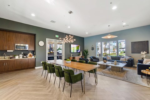 a living room and dining room with a table and chairs