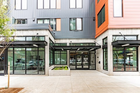 A modern building with a grey and orange facade.