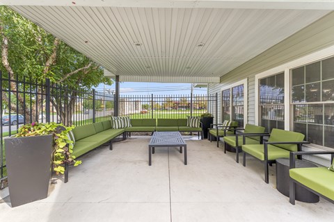 A patio with a table and chairs.