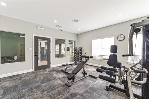 A spacious home gym with a variety of exercise equipment.