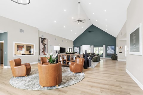 A living room with a rug and chairs.