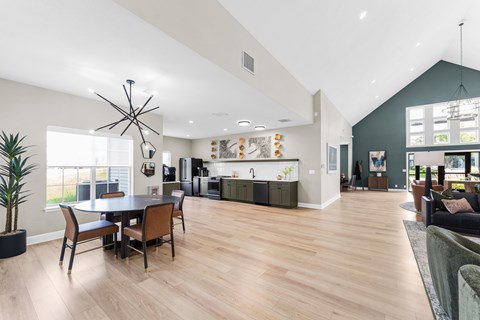 A modern open plan living and dining room with wooden floors and furniture.