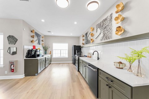 A modern kitchen with wooden floors and a white countertop.