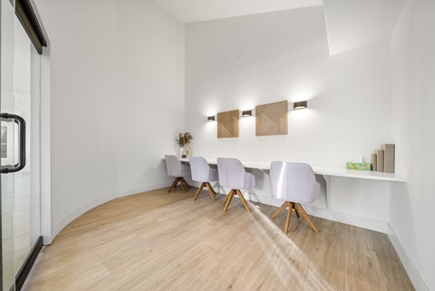 A conference room with a long table and chairs.