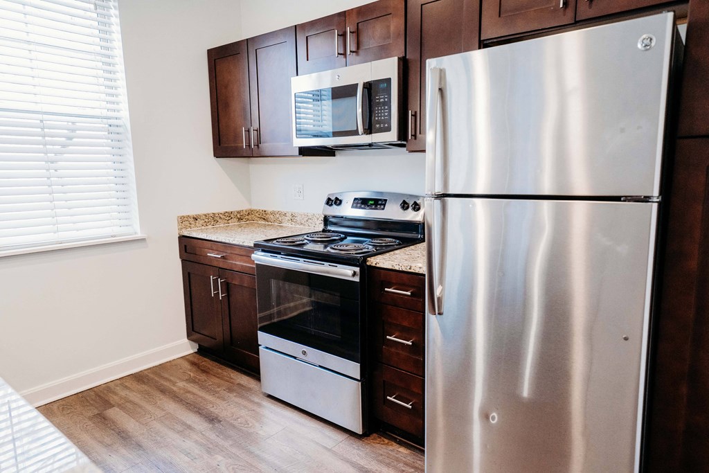 a kitchen with stainless steel appliances and wooden cabinets