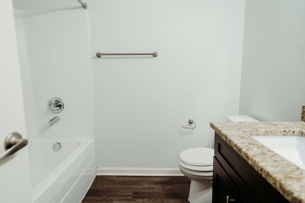a bathroom with a toilet and a shower and a sink